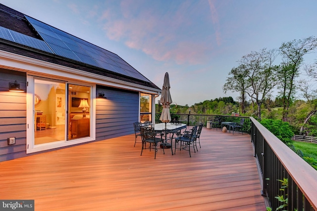 wooden terrace with outdoor dining area