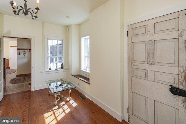 348 Rosemont Ringoes Rd, Stockton, NJ 08559 - hallway featuring a chandelier, wood-type flooring, and baseboards