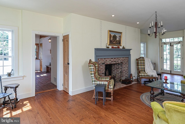 348 Rosemont Ringoes Rd, Stockton, NJ 08559 - living area featuring wood finished floors, baseboards, a chandelier, a brick fireplace, and recessed lighting