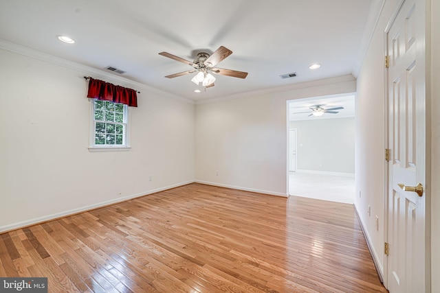 spare room with ceiling fan, light wood-style flooring, baseboards, recessed lighting, and crown molding