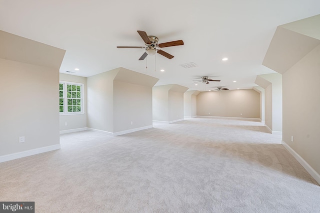 additional living space with ceiling fan, light colored carpet, recessed lighting, and baseboards