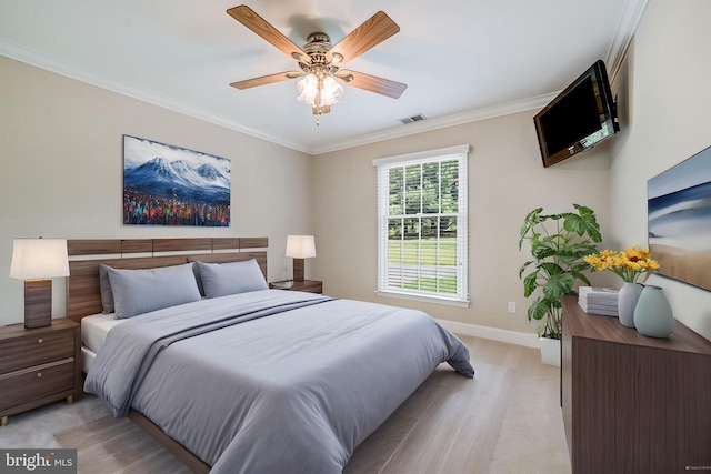 bedroom featuring baseboards, crown molding, light colored carpet, and a ceiling fan
