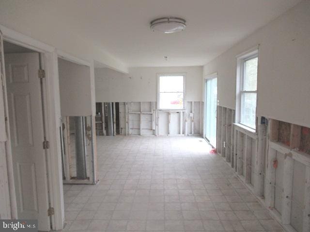 hallway with plenty of natural light and light flooring