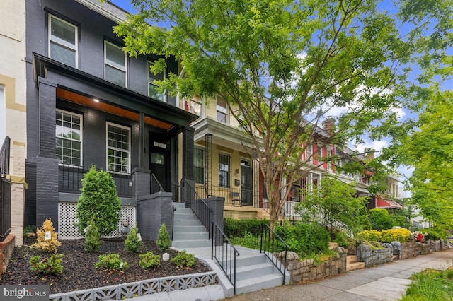 1129 8th St NE, Washington, DC 20002 - view of front facade featuring covered porch and brick siding
