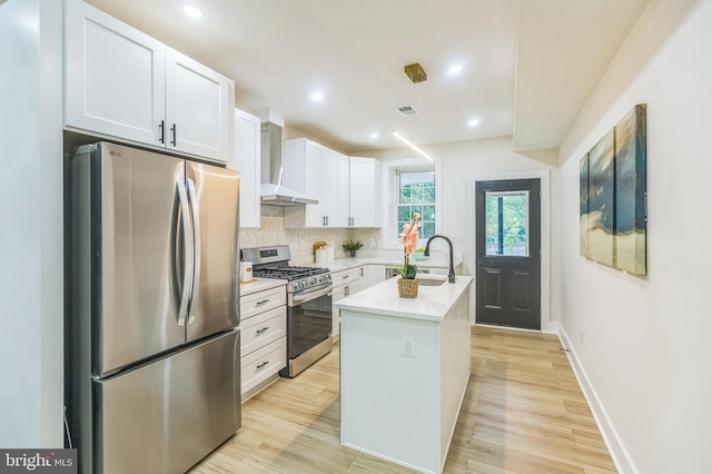 1129 8th St NE, Washington, DC 20002 - kitchen with stainless steel appliances, wall chimney exhaust hood, a sink, light countertops, and decorative backsplash