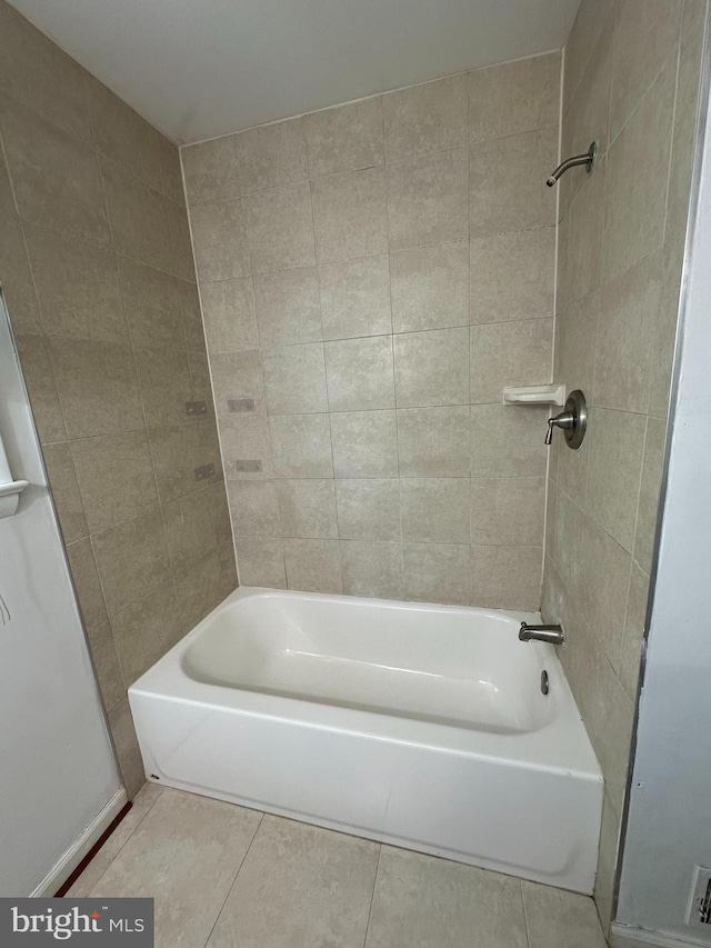 full bathroom featuring tile patterned flooring and bathing tub / shower combination