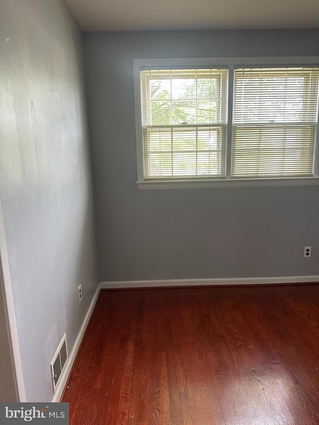 unfurnished room featuring wood finished floors and baseboards