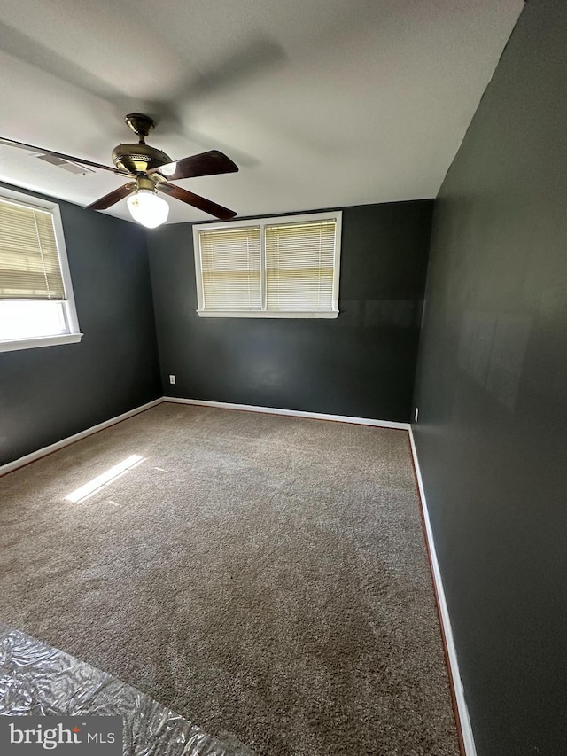 spare room featuring carpet and ceiling fan