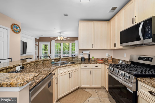 5942 Kimberly Anne Way, Alexandria, VA 22310 - kitchen featuring appliances with stainless steel finishes, a sink, a ceiling fan, a peninsula, and dark stone counters