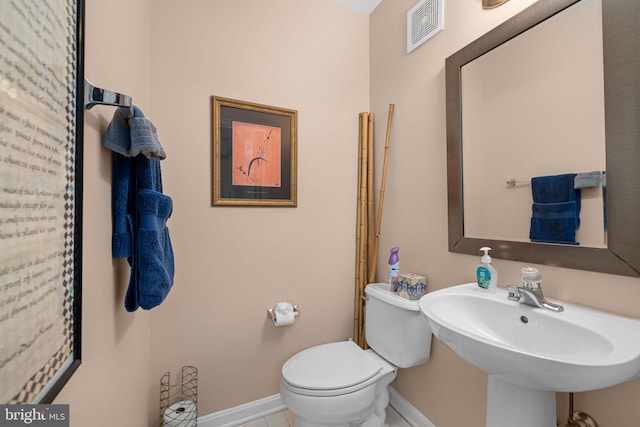 5942 Kimberly Anne Way, Alexandria, VA 22310 - bathroom featuring baseboards, toilet, tile patterned flooring, and a sink