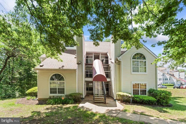 1013 Fallcrest Ct Unit 4-203, Bowie, MD 20721 - traditional home featuring a sunroom, stairs, a shingled roof, and a chimney