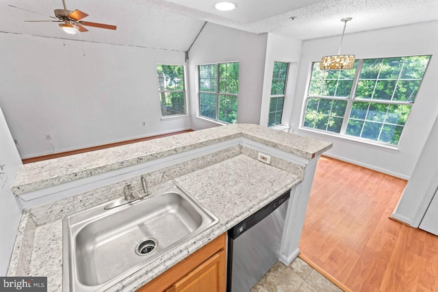 1013 Fallcrest Ct Unit 4-203, Bowie, MD 20721 - kitchen featuring stainless steel dishwasher, a sink, lofted ceiling, hanging light fixtures, and a textured ceiling