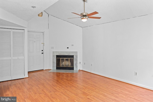 1013 Fallcrest Ct Unit 4-203, Bowie, MD 20721 - unfurnished living room with a ceiling fan, light wood-style flooring, a textured ceiling, lofted ceiling, and a fireplace