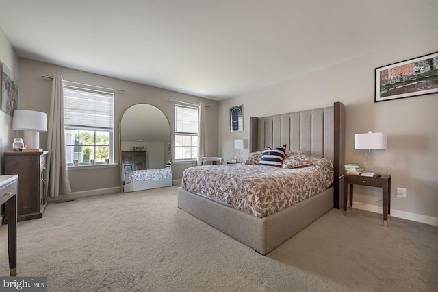 bedroom featuring carpet floors and baseboards