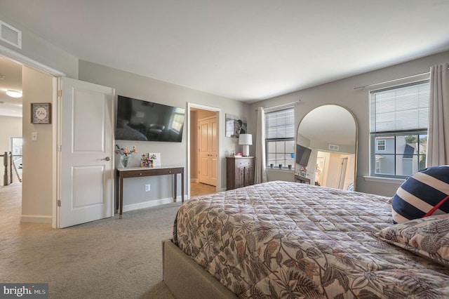 carpeted bedroom featuring baseboards