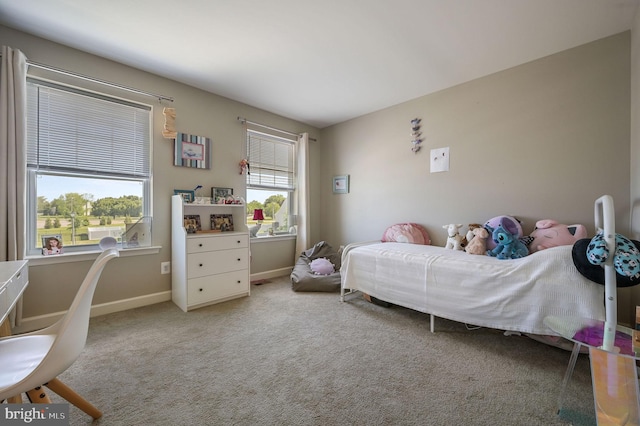 carpeted bedroom featuring baseboards