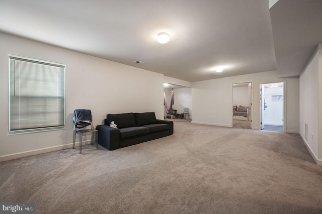 living area featuring carpet and baseboards
