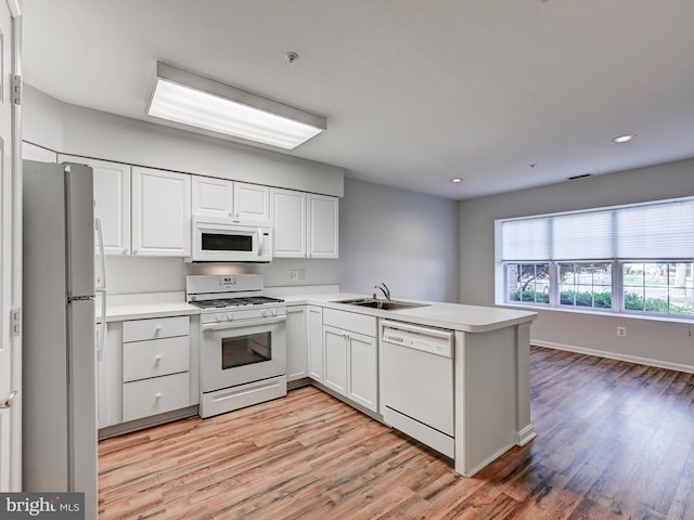12111 Tullamore Ct Unit 101, Lutherville Timonium, MD 21093 - kitchen with white appliances, a sink, light wood-style floors, a peninsula, and recessed lighting