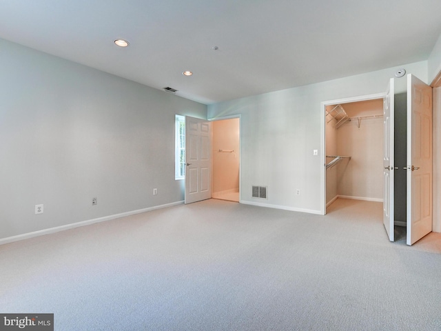 12111 Tullamore Ct Unit 101, Lutherville Timonium, MD 21093 - unfurnished bedroom with baseboards, light carpet, recessed lighting, and a walk in closet