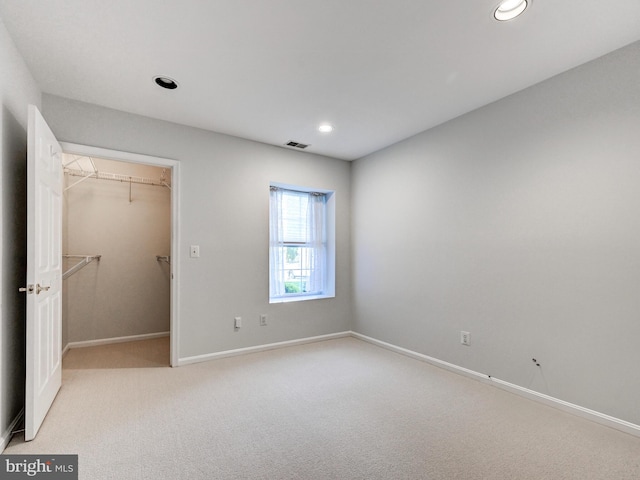 12111 Tullamore Ct Unit 101, Lutherville Timonium, MD 21093 - unfurnished bedroom featuring a spacious closet, baseboards, light colored carpet, recessed lighting, and a closet