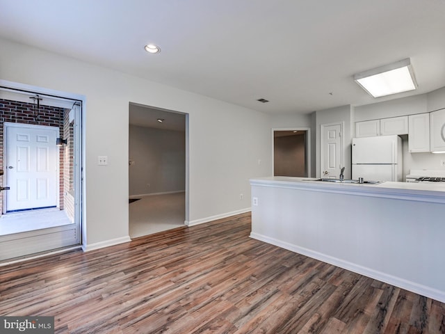 12111 Tullamore Ct Unit 101, Lutherville Timonium, MD 21093 - kitchen with freestanding refrigerator, wood finished floors, a sink, white cabinets, and baseboards