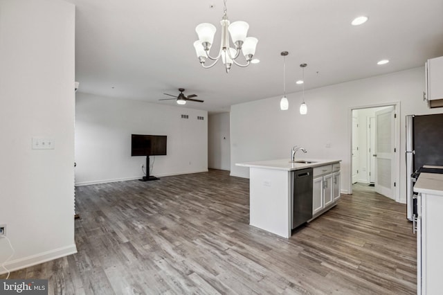 kitchen featuring dishwasher, wood finished floors, hanging light fixtures, a chandelier, and recessed lighting