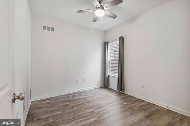 unfurnished room featuring wood finished floors, a ceiling fan, and baseboards