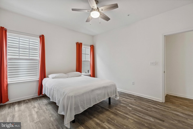 bedroom featuring wood finished floors, baseboards, and ceiling fan