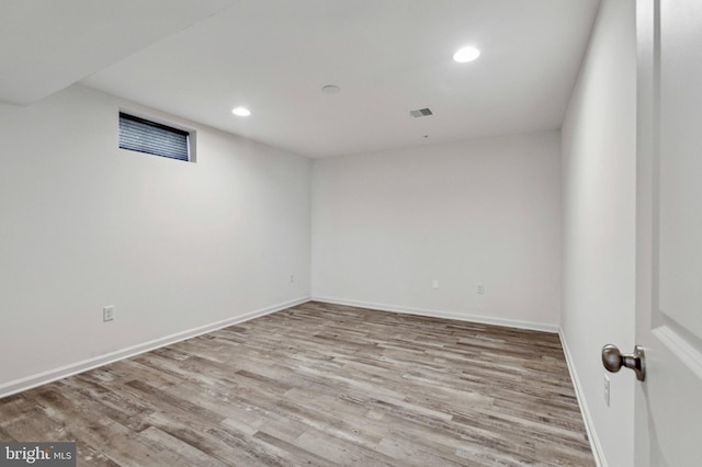 finished below grade area with wood finished floors, recessed lighting, and baseboards