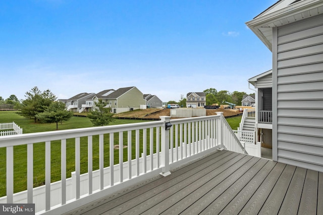deck with a residential view and a lawn