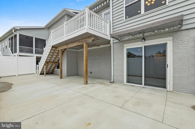 back of house with a patio, stairway, a wooden deck, ceiling fan, and a sunroom