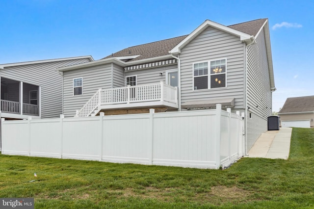 back of property with a shingled roof