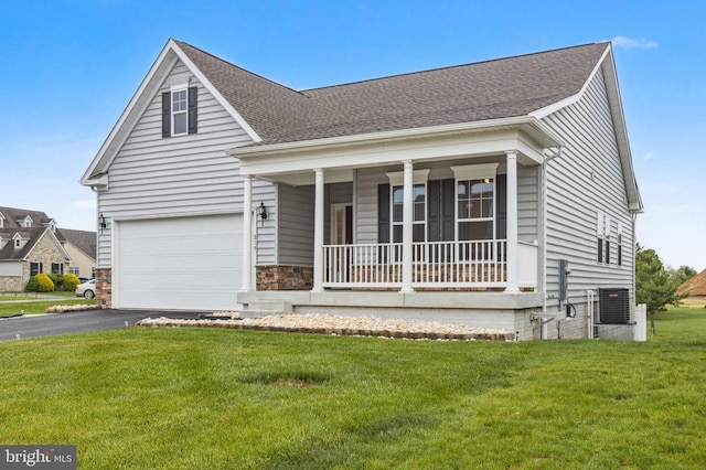 traditional-style home with covered porch, a front lawn, driveway, roof with shingles, and cooling unit
