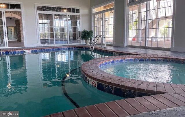 view of swimming pool featuring a pool with connected hot tub