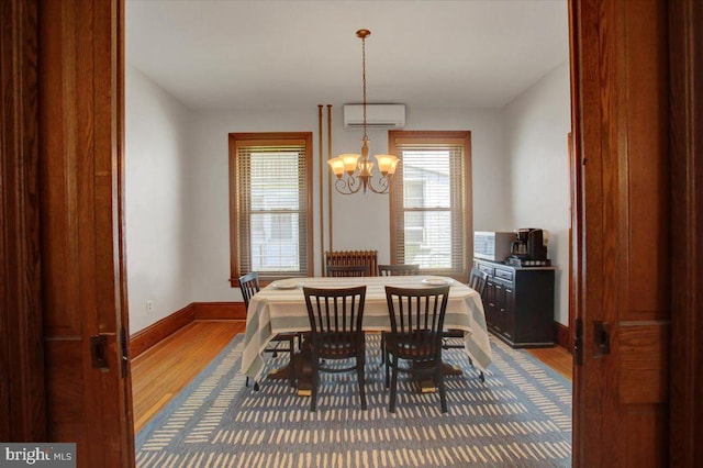 145 S Washington St, Greencastle, PA 17225 - dining room featuring a wall mounted air conditioner, wood finished floors, healthy amount of natural light, and a chandelier