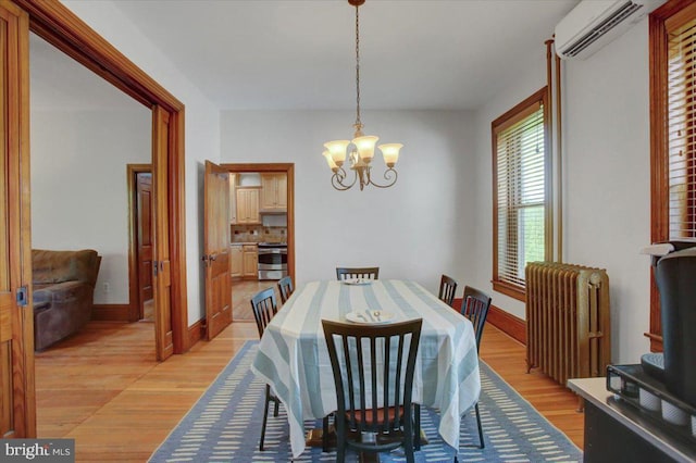 145 S Washington St, Greencastle, PA 17225 - dining room with radiator, a wall mounted air conditioner, a chandelier, and light wood finished floors