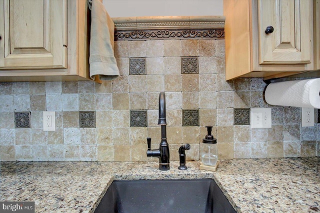 145 S Washington St, Greencastle, PA 17225 - kitchen featuring a sink, decorative backsplash, light brown cabinets, and light stone counters