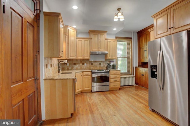 145 S Washington St, Greencastle, PA 17225 - kitchen with stainless steel appliances, radiator heating unit, a sink, tasteful backsplash, and recessed lighting