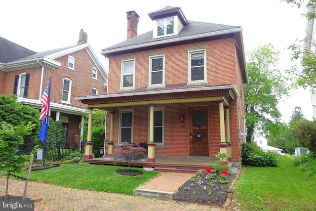 145 S Washington St, Greencastle, PA 17225 - american foursquare style home with a porch, brick siding, and a front yard