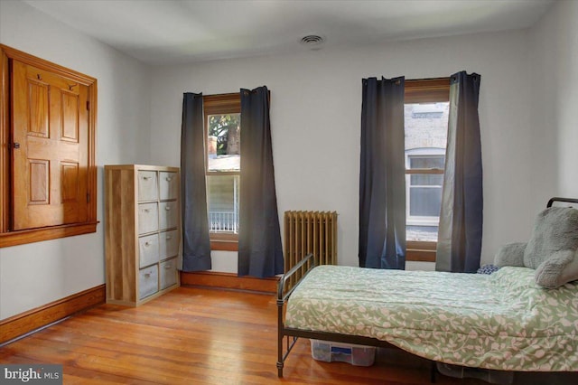 145 S Washington St, Greencastle, PA 17225 - bedroom featuring radiator, multiple windows, and wood-type flooring