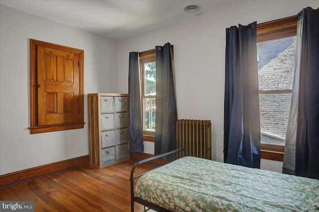 145 S Washington St, Greencastle, PA 17225 - bedroom featuring radiator, hardwood / wood-style floors, and baseboards