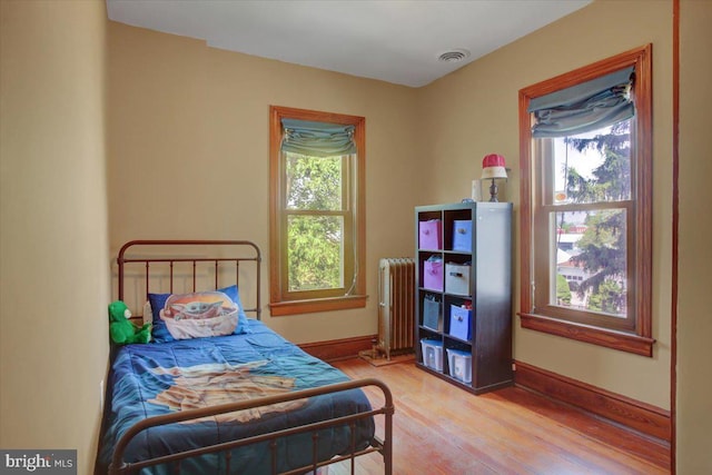 145 S Washington St, Greencastle, PA 17225 - bedroom with radiator heating unit, wood finished floors, and baseboards