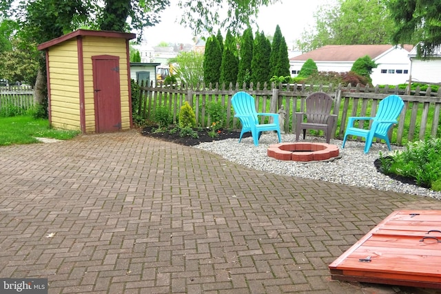 145 S Washington St, Greencastle, PA 17225 - view of patio featuring a storage shed, an outdoor fire pit, an outdoor structure, and fence