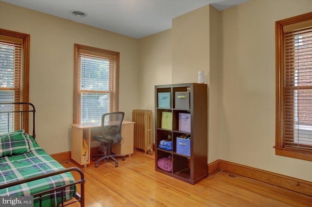 145 S Washington St, Greencastle, PA 17225 - bedroom with light wood finished floors, multiple windows, baseboards, and radiator