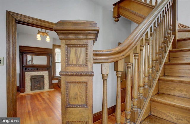 145 S Washington St, Greencastle, PA 17225 - staircase featuring wood finished floors and a fireplace with flush hearth