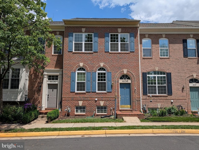 view of property featuring brick siding