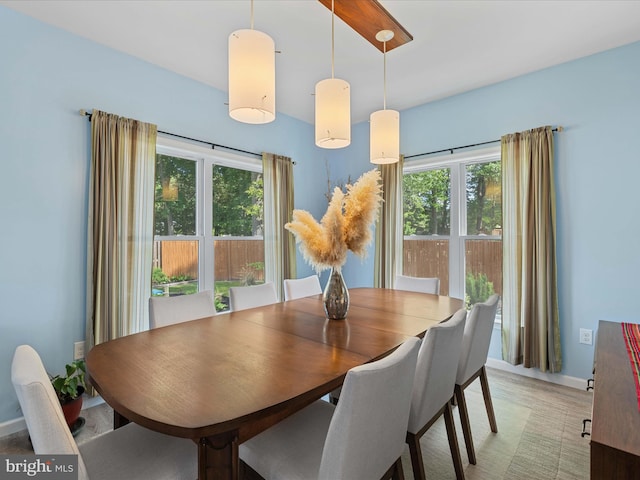 dining space with plenty of natural light and baseboards