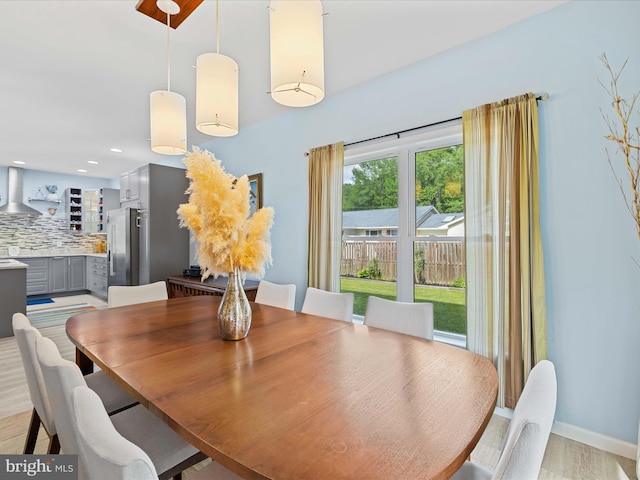 dining area with baseboards and recessed lighting