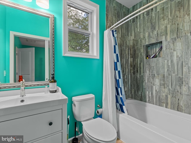 full bath with toilet, vanity, and shower / tub combo with curtain