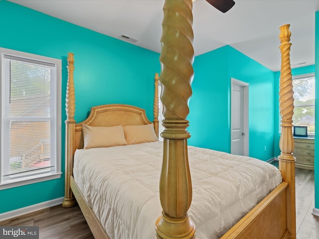 bedroom with baseboards, wood finished floors, and a ceiling fan